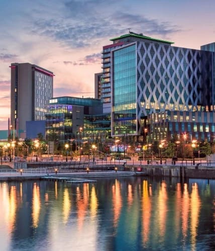 a view of a city at night at Vox Apartments, Manchester, M15 4YD