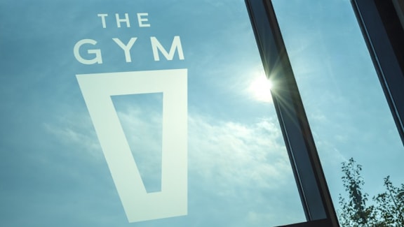 the gym logo on window with sky background at The Keel Apartments, Liverpool, L3 4GE