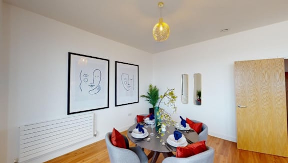 a dining room with a table and chairs at The Keel Apartments, Liverpool, L3 4GE