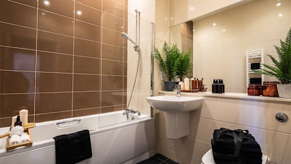 a bathroom with a sink and a bath tub at The Keel Apartments, Liverpool, L3 4GE
