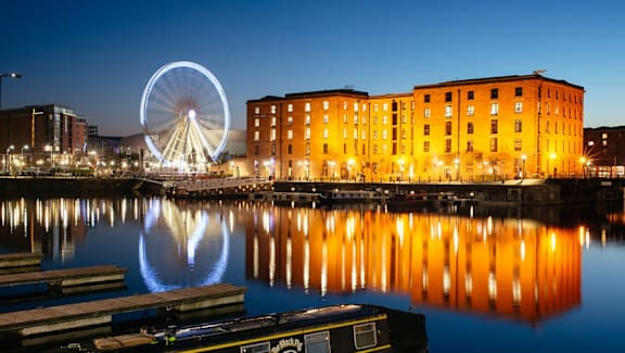 a view of a city at night with a ferris wheel at The Keel Apartments, Liverpool, L3 4GE