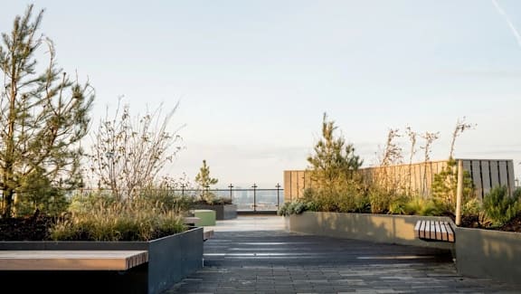 the roof of the building has benches and plants at Vox Apartments, Manchester, M15 4YD