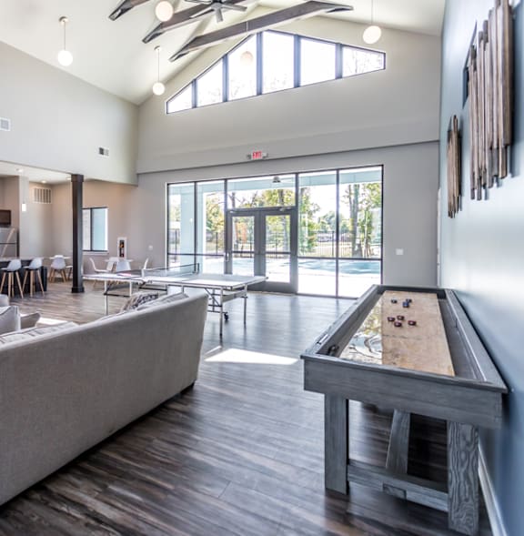 A spacious living room with a pool table and a view of the outdoors.