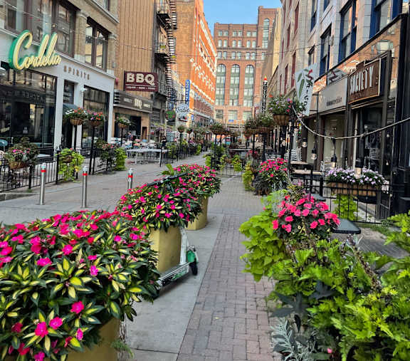 A city street with a row of flower pots on the sidewalk.at East 4th Street, Cleveland, OH