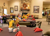 Thumbnail 10 of 11 - A dining room with tables set for a meal.