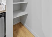 Thumbnail 24 of 26 - A small green plant sits on the top shelf of a white shelving unit.