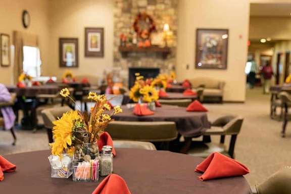 A dining room with tables set for a meal.