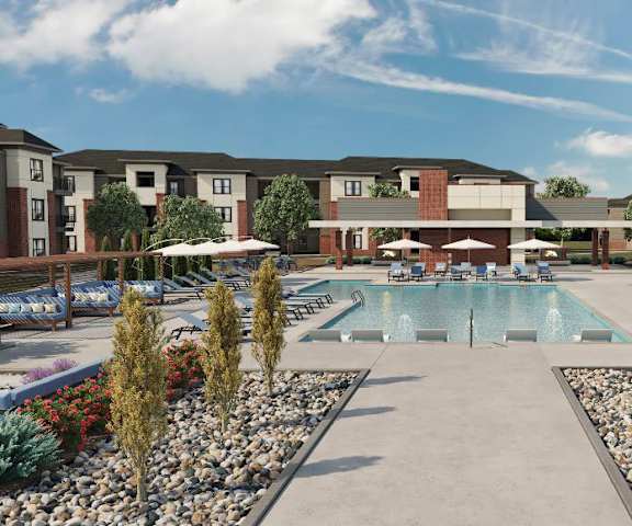 The pool at 49 West with pool chairs, umbrellas, and plants surrounding it. 