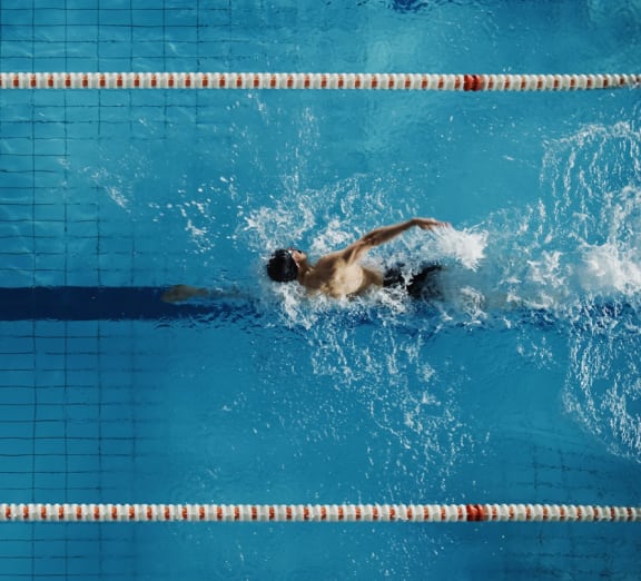 a swimmer competes in a pool
