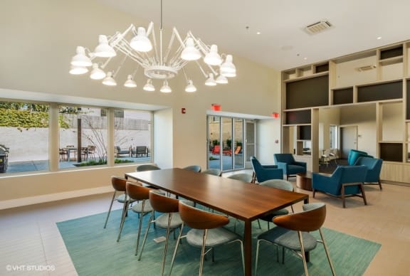 a conference room with a long table and chairs and a large window with a view of the