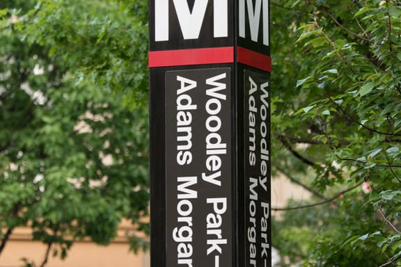 a sign for a restaurant in front of a tree at Connecticut Park Apartments, Washington, 20008