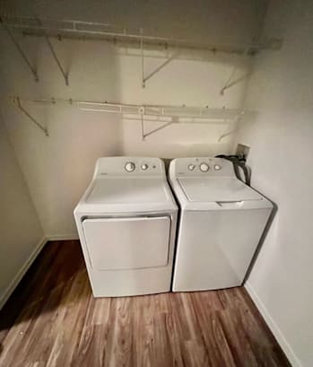 a small laundry room with two washers and a dryer