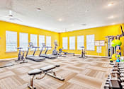 Thumbnail 11 of 34 - fitness center with cardio equipment and free weights at the flats at sundown apartments in north port florida