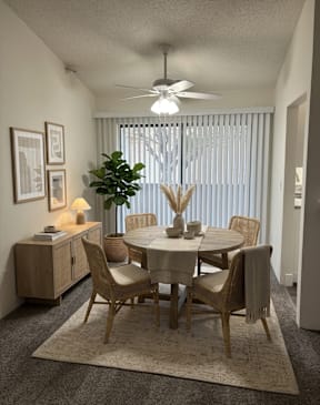Dining area with table and chairs in apartment layout at Muirfield Apartments (furniture not included).