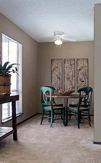 A dining room table with chairs and a window.