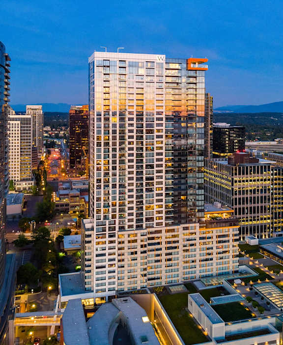 an aerial view of a skyscraper in a city at night at Two Lincoln Tower Apartments, Bellevue, WA, 98004