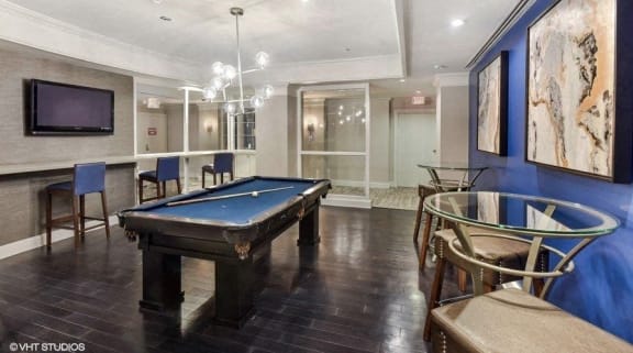a game room with a pool table and a tv