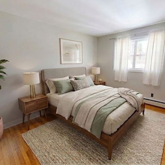 A bedroom with a large bed and a painting on the wall.