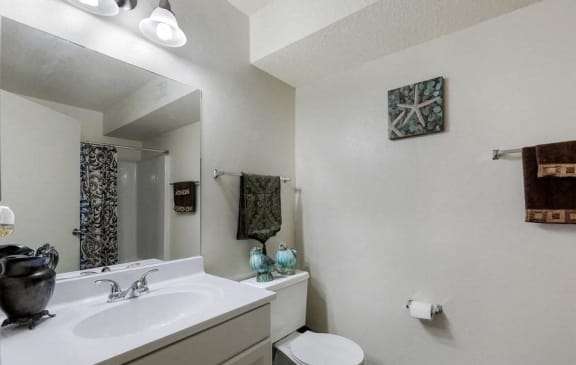 Model bathroom with white countertop and cabinets