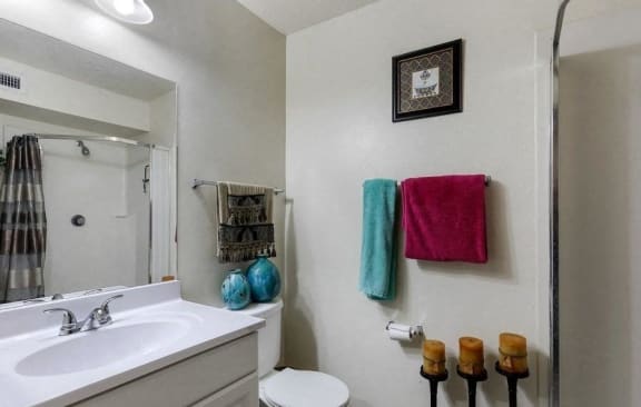 Model bathroom with white countertop and cabinets