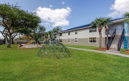Playground in courtyard with grass and building exterior
