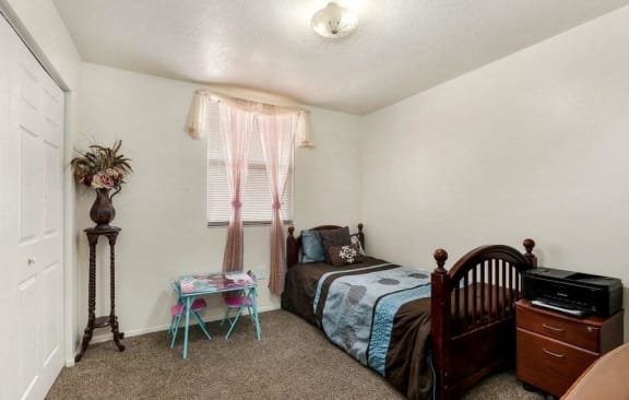 Model bedroom with twin bed and nightstand