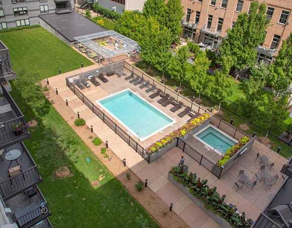 A backyard with a pool and a deck.