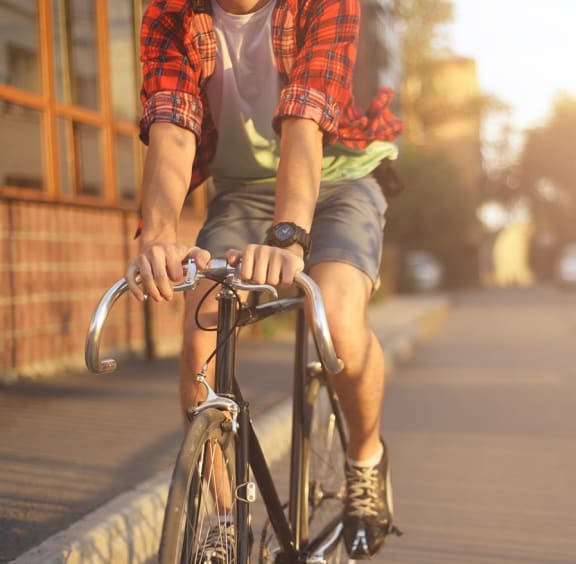Man Riding Bike at The Brook at Colombia Apartments in Columbia, Maryland