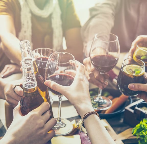 a group of people holding up glasses of wine