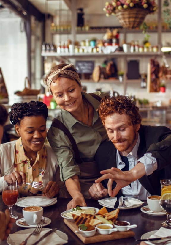 a group of people sitting at a table in a restaurant