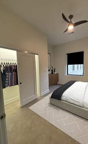 A bedroom with a bed, a dresser, and a window. at The Annex Apartments, Buffalo, NY, 14222