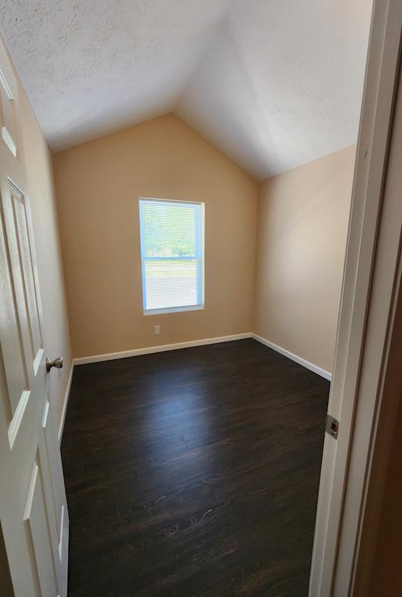 A room with a window and wooden floors.