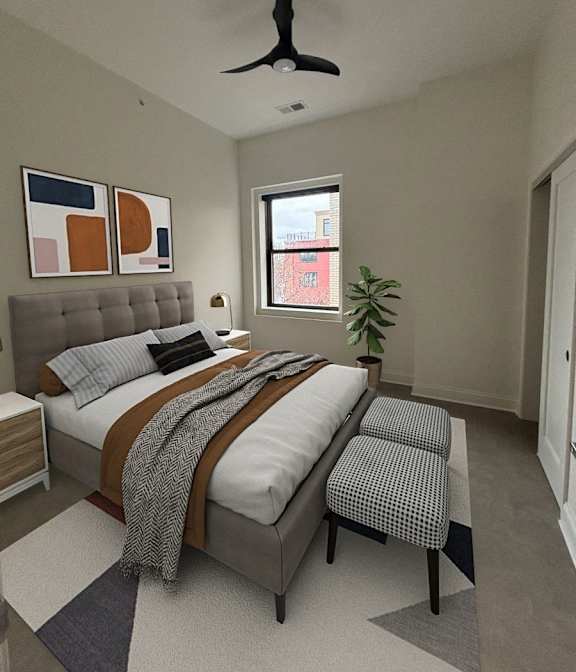 A bedroom with a bed, a ceiling fan, and a window. at The Annex Apartments, Buffalo, NY, 14222