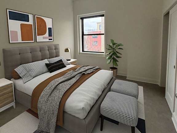 A bedroom with a bed, a ceiling fan, and a window. at The Annex Apartments, Buffalo, NY, 14222
