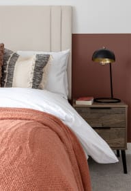 a bedroom with a bed and a nightstand at Leaf Living Nottingham