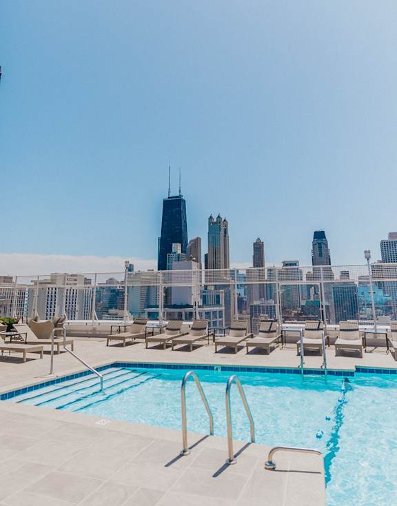 A pool with a city skyline in the background.
