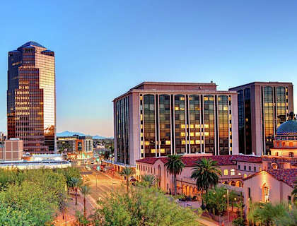 A cityscape with buildings and palm trees.