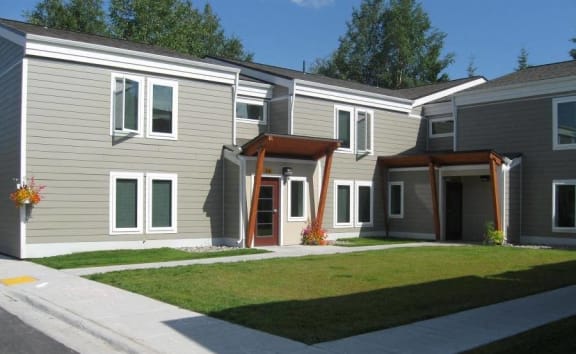 Father playing with kids in apartment at Tanana Apartments, North Pole