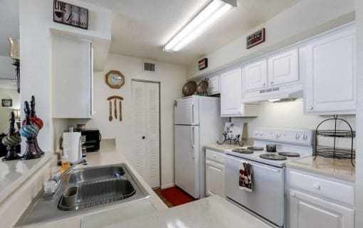 Kitchen model with white cabinets and white appliances