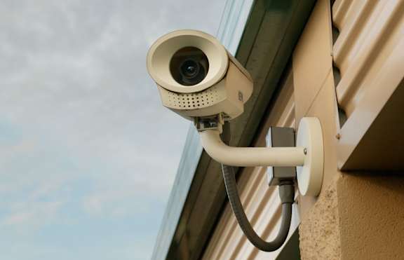 A security camera is mounted on a building.