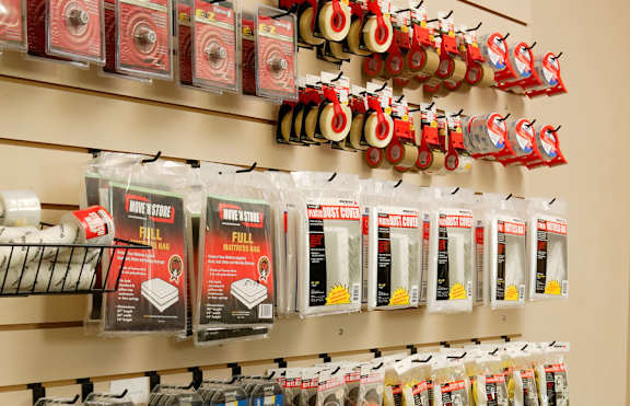 A wall of red and white packaged items are on display.