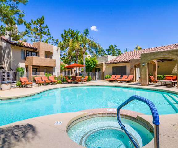 The outdoor pool with pool chairs, tables, and chairs at Desert Horizon. 
