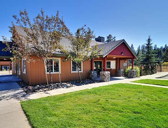the front of the home with a sidewalk leading to the front door