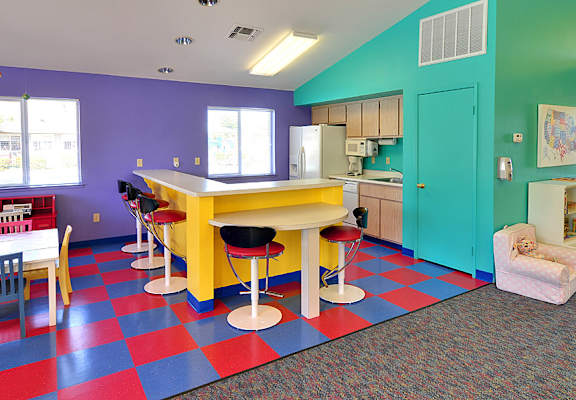 A kitchen with a yellow table and chairs.