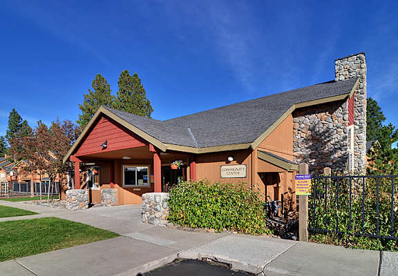 A small building with a red roof and a sign that says "Community Center".