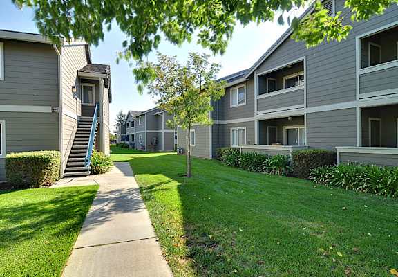Apartment complex with a walkway in the foreground.