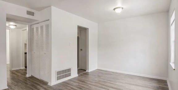 a room with a wooden floor and white walls