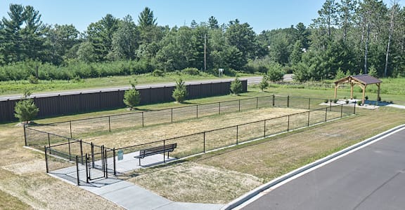 A park with a playground and a bench.