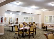 Thumbnail 3 of 6 - a dining area with tables and chairs in a room