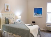 Thumbnail 5 of 6 - a bedroom with a bed and two windows